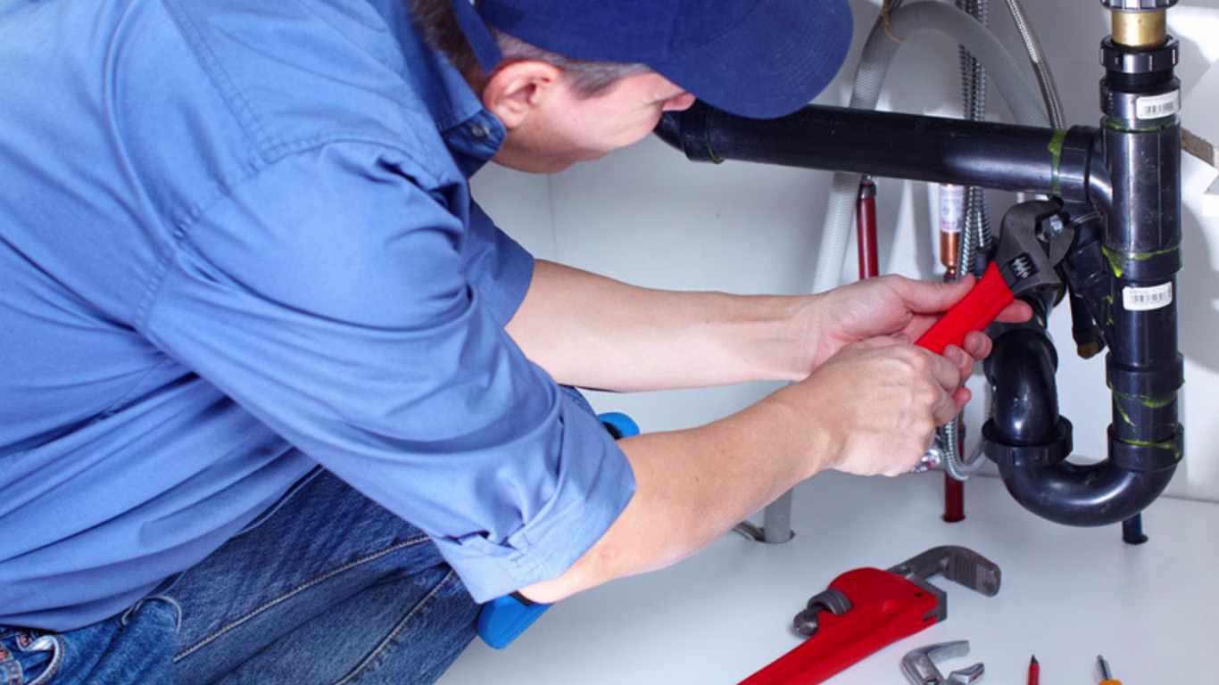 local plumbers in ballito Local plumber in Ballito fixing a kitchen sink with professional tools.